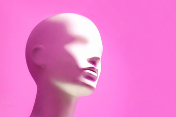 Head of white mannequin on pink background. Faceless girl. - obrazy, fototapety, plakaty