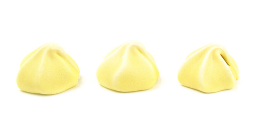 Line of Three Yellow Meringues on a White Background