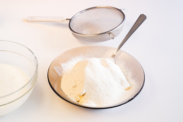Making dough by female hands on white table
