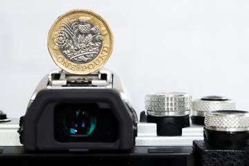 British Money, Pound coin on top of a Mirrorless DSLR Camera
