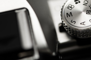 Close-up macro shot of a modern digital SLR camera with the dial in Manual Mode