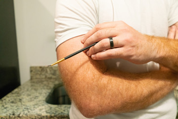 Man Holding Paintbrush