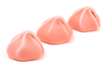 Line of Three Pink Meringues on a White Background