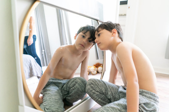 Boy looking at camera from mirror