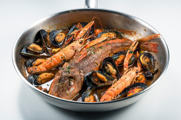 Pan with Tub gurnard prawn mussels olives and tomatoes