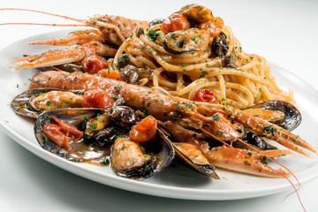 Plate of spaghetti with prawn mussels olives and tomatoes