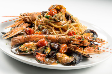 Plate of spaghetti with prawn mussels olives and tomatoes