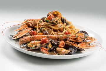 Plate of spaghetti with prawn mussels olives and tomatoes