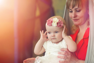Baby in the arms of the girl. Mom holds her child in her arms. Happy mother with a little baby.