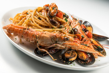 Plate of spaghetti with prawn mussels olives and tomatoes