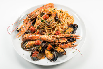 Plate of spaghetti with prawn mussels olives and tomatoes