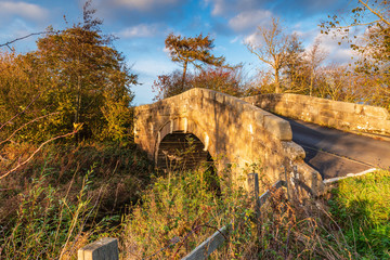Fototapeta na wymiar Shilvington Bridge over River Blyth, on a minor road between Ogle and Shilvington lies this 18th century humped back bridge