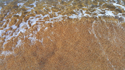 Fototapeta na wymiar Clear sea water in the coastal sand