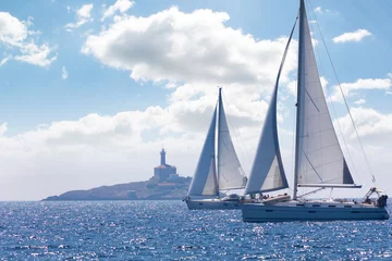 Fotobehang two sailing ships near a lighthouse in summer day, Croatia © Milan Noga reco