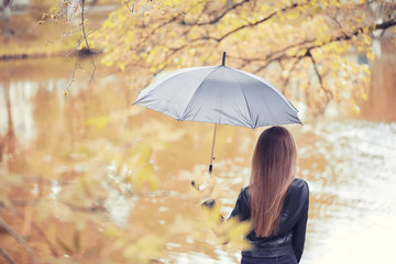 Young girl in autumn park