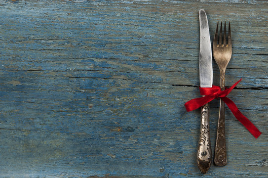 Antique cutlery on dark wooden background