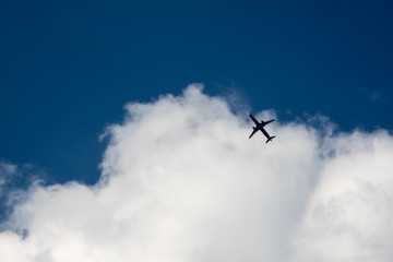 Fototapeta na wymiar The plane flies in the clouds