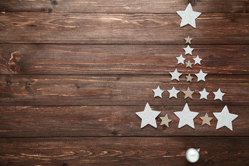 Silver stars in shape of christmas tree on wooden table