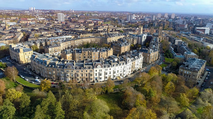 Low level aerial image over the autumn foliage of trees in Kelvingrove Park, Glasgow, to the elegant buildings of Park Circus. © TreasureGalore