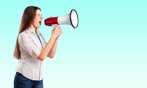 Portrait of woman holding megaphone, dressed in pin-up style