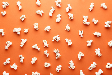 Salted popcorn on orange background