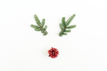 Christmas, New Year minimal concept. Christmas deer symbol made of fir branches and red decoration...