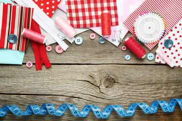 Fototapeta premium Sewing accessories on grey wooden table