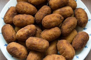 close-up of homemade fried croquettes served on a plate. Typical food in Spain and France