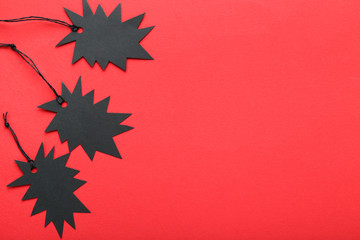 Black sale tags on red background