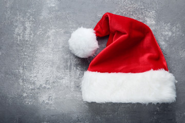 Red santa hat on grey wooden table