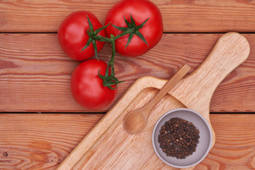 tomatoes, peppers on a wooden plate. country style