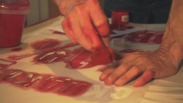 The artist's hands inflicted red paint