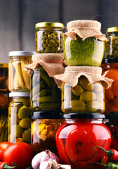 Jars with variety of pickled vegetables.