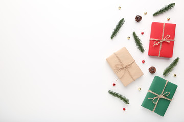 Christmas gift boxes with fir tree branches on white background