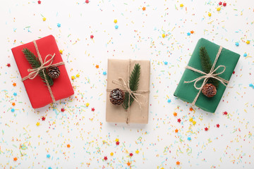 Christmas gift boxes with colorful sprinkles on white background