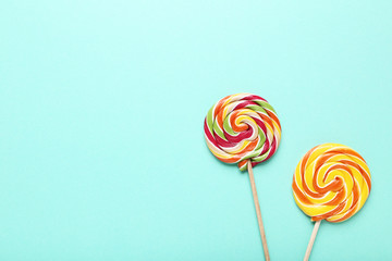 Colorful lollipops on mint background