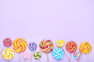 Fototapeta na wymiar Colorful lollipops on purple background