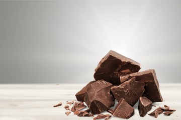Close-up broken chocolate bar isolated on white background