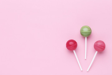 Sweet lollipops on pink background