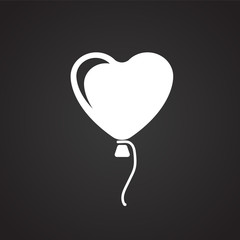 Heart shape air balloon on black background icon