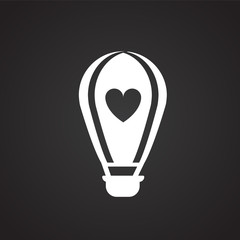 Hot air balloon with heart on black background icon