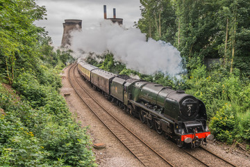 A Steam Train In Britain Passing A Power Station © crofty136