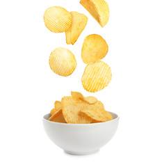 Bowl of tasty ridged potato chips on white background