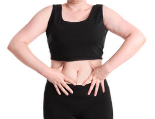 Overweight woman touching belly fat before weight loss on white background