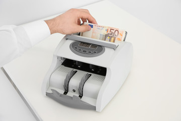 Man with toilet paper in pocket suffering from diarrhea on color background