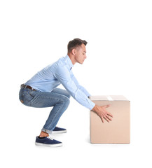 Full length portrait of young man lifting heavy cardboard box on white background. Posture concept