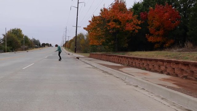 Skateboarder skating down a street