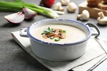 Bowl of fresh homemade mushroom soup on white background, top view