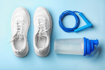 Flat lay composition with jump rope on color background