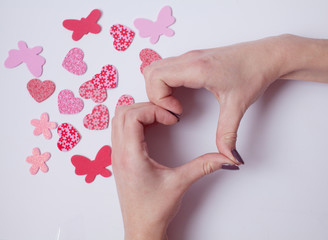 Female hand showing heart shape gesture. Isolated on white. `Happy Valentine's day